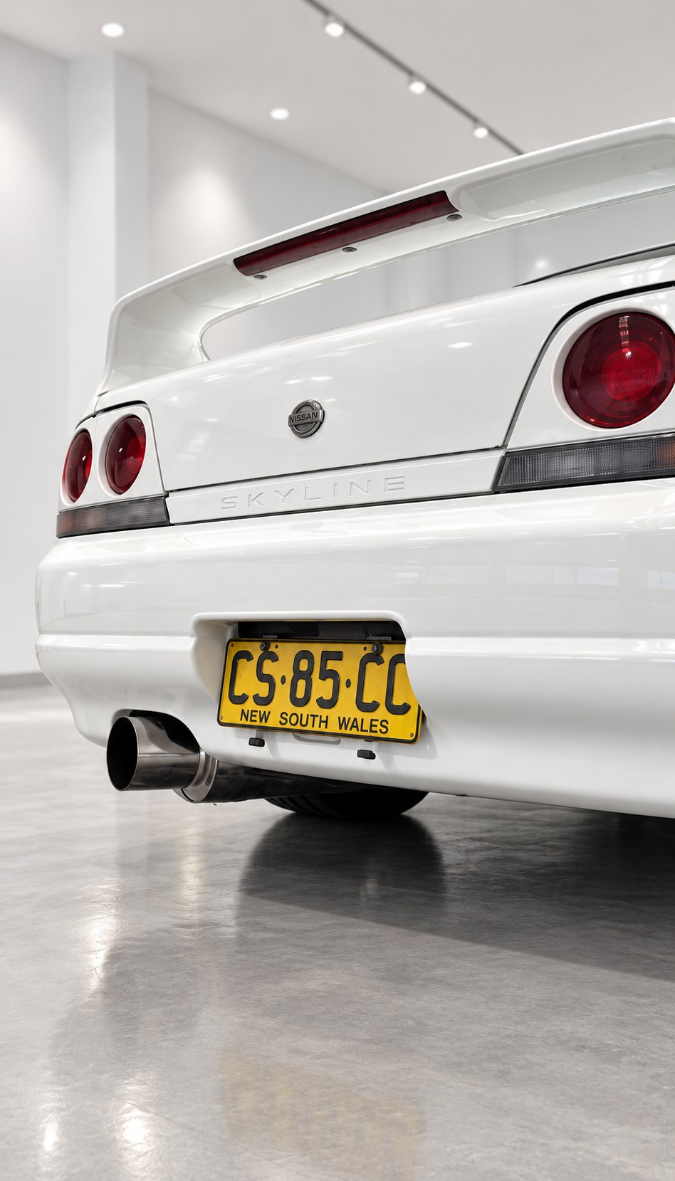 White Nissan Skyline rear in a showroom